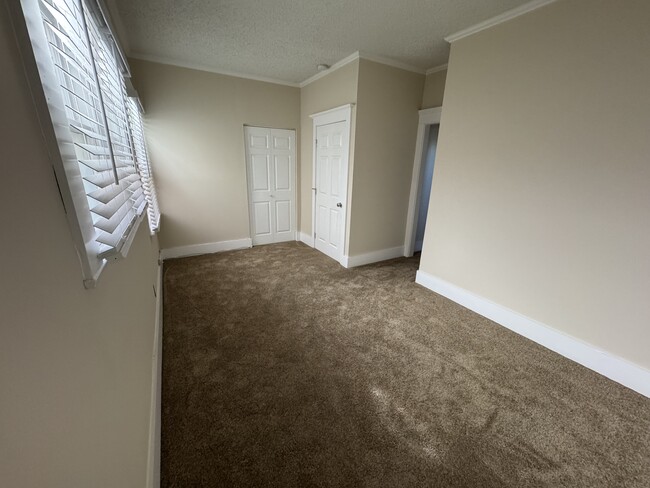 Newly renovated primary bedroom. Bathroom entrance is through the opening on the right. - 1749 E 3rd St