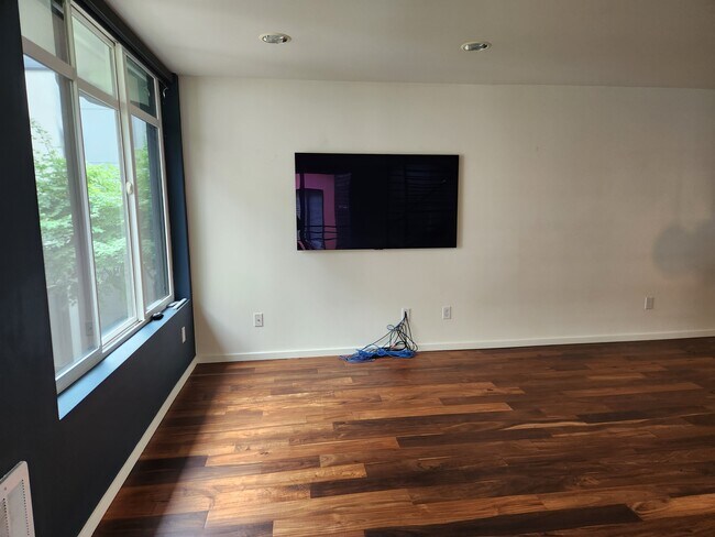 Living space with wall mounted smart TV included - 2118 NE 89th St