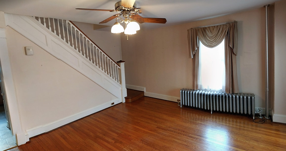 Living room, looking toward stair case. NOTE: all pictures were taken before the interior was repainted - none of the old wall paper remains. - 925 North Market Street
