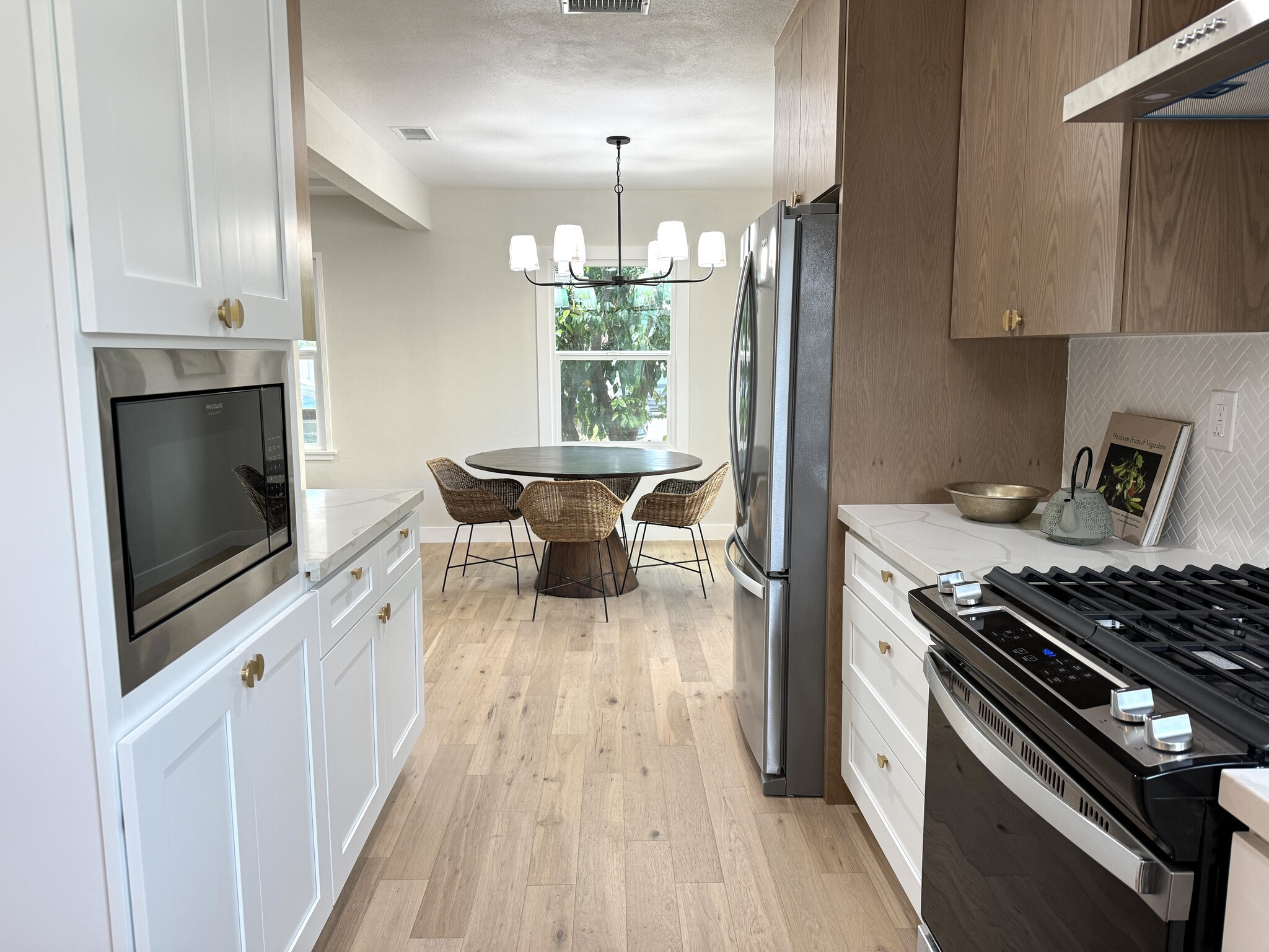 Kitchen with brand new stainless steel appliances to the left and living room to the right - 5950 Simpson Ave