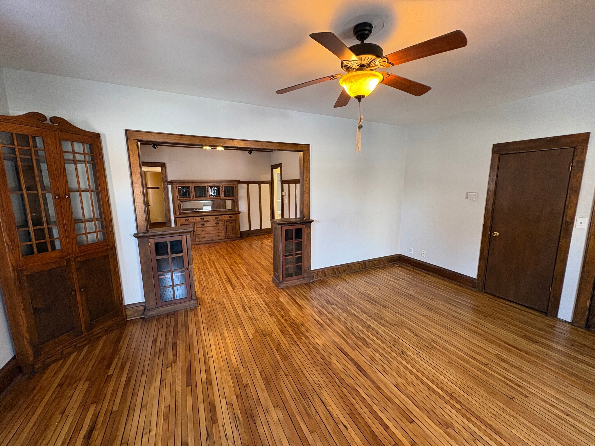 Spacious living room with open plan to sunroom and dining room - 509 W 22nd St