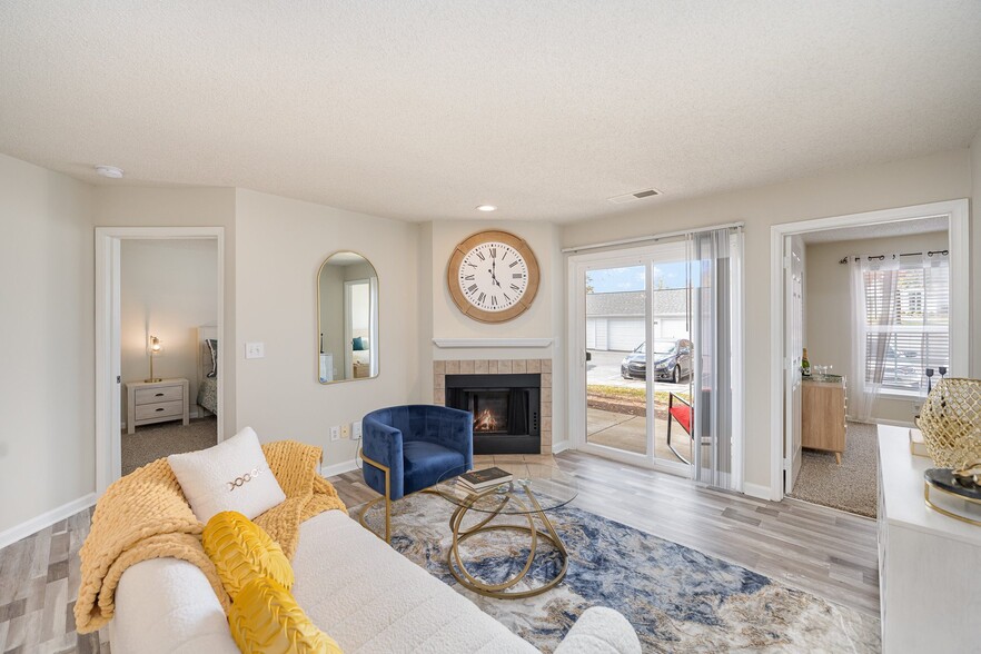 Living Room with Fireplace and Woodgrain Flooring - Reserve at Hamburg