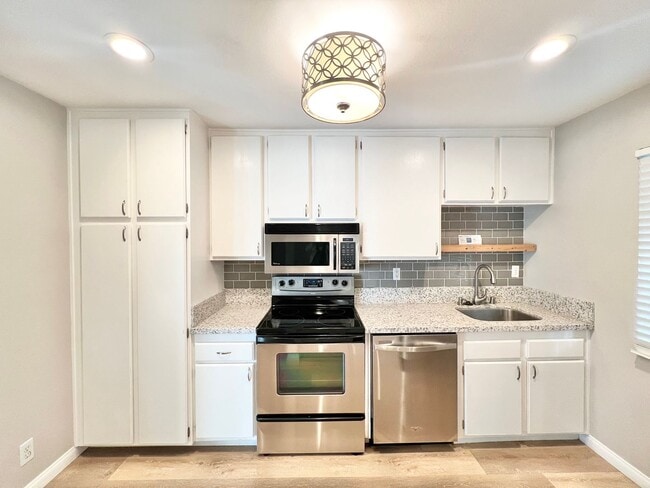 Building Photo - Contemporary 2 Bed Condo with 2 Garage Parking Spaces, Community Pool, and 3 Private Balconies