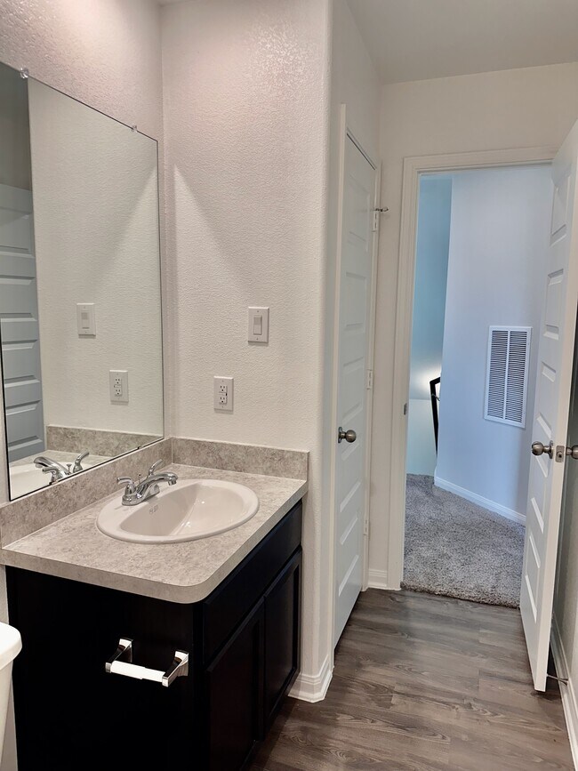 The upstairs secondary bathroom is spacious and also features a linen closet. - 730 Tejas Village Pky
