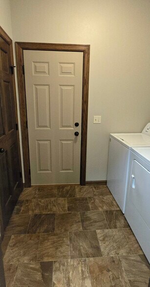 Laundry with Storage on and access to 2 Car Garage. - 3511 E Bison Trl