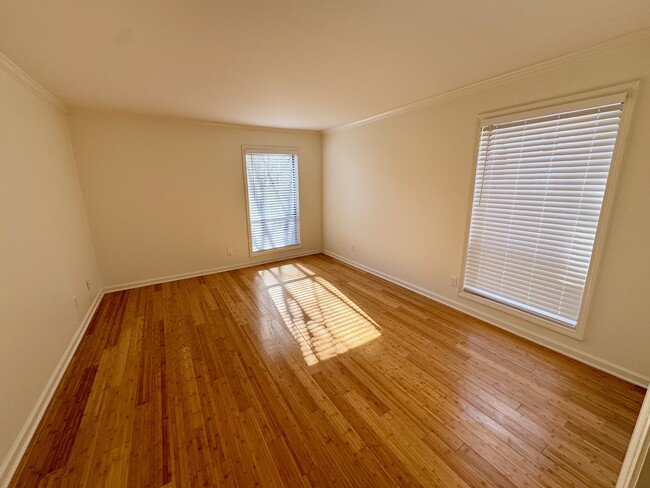 large bedroom accommodates a king bed and one or two dressers (depending on size), and a small chair - 209 14th St. NE #119