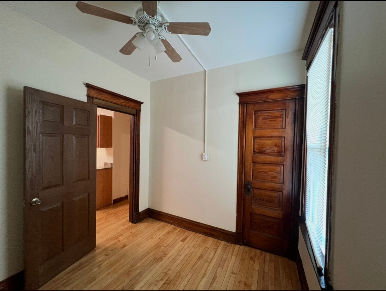 Number one bedroom with a closet and ceiling fan - 3748 W Lyndale St