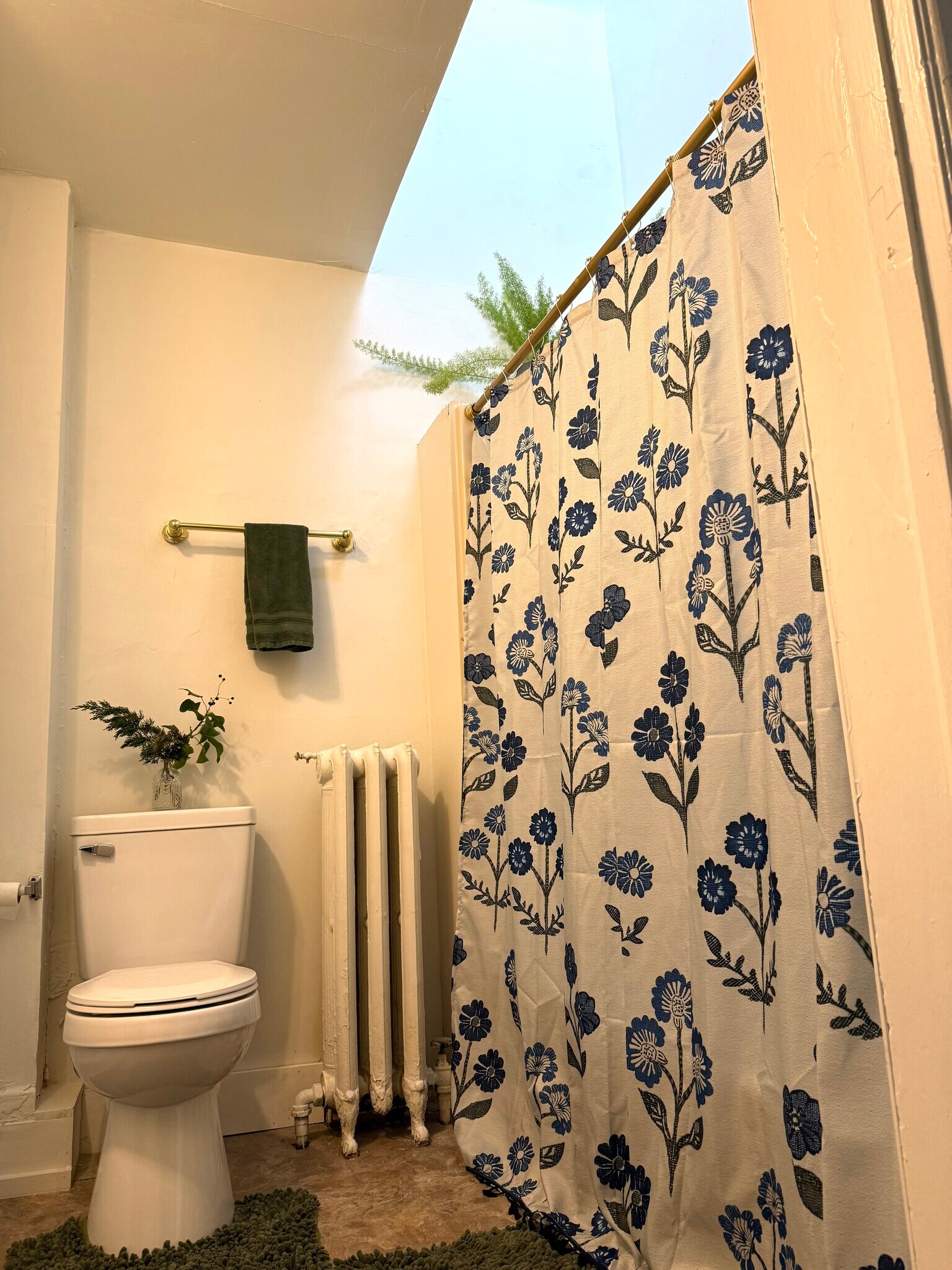 Full bath upstairs with a large glowing skylight above the bath tub. - 206 N Bethlehem Pike