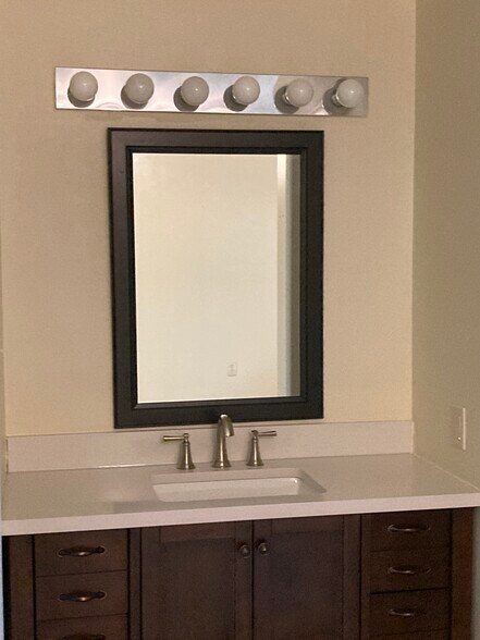 Bedroom 2 - en suite bathroom with new cabinet, mirror and faucet. - 185 Eagle Peak Cir