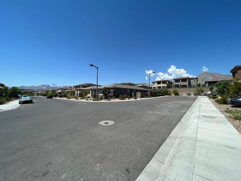 View of corner lot and ample parking space on side, overlooked by mountains - 331 Coastal Redwood St