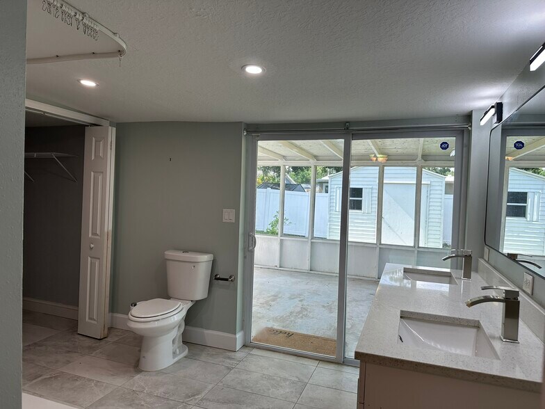 master bathroom with access to back porch - 5932 McKee Lake Dr N