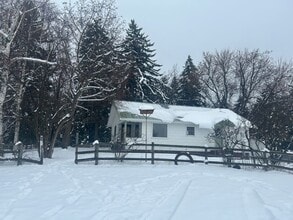 Building Photo - Bigfork Rodeo Farmhouse~ Fenced garden, greenhouse, garage, barn and shop!
