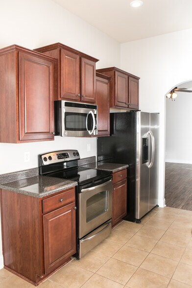 kitchen with stainless appliances, living room in background - 307 Dovington Dr