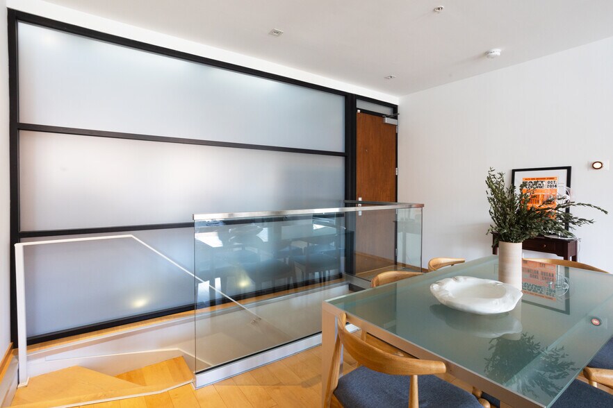 Staircase from kitchen and dining area leading downstairs to the primary bedroom and bathroom. - 2250 11th St NW