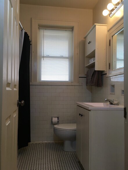 Bathroom features original tile flooring - 4973 Tholozan Ave