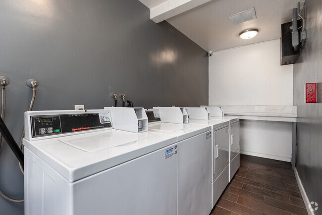 Laundry room - Charming Courtyard Apartments in West Adam...