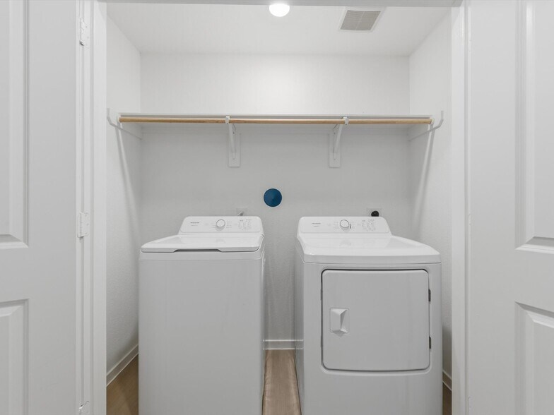 Large laundry space with overhead shelving - 25409 Carnation Ct
