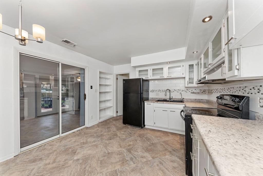 Beautiful, updated kitchen with glass front cabinets and tons of storage! All appliances - including range, refrigerator, dishwasher. Kitchen opens to Sunroom, charming patio and fully fenced back yard. - 11 Lawndale Ave