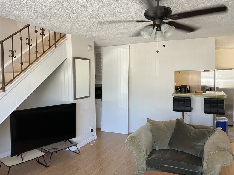 living area view to kitchen & upstairs - 3911 Huron Ave