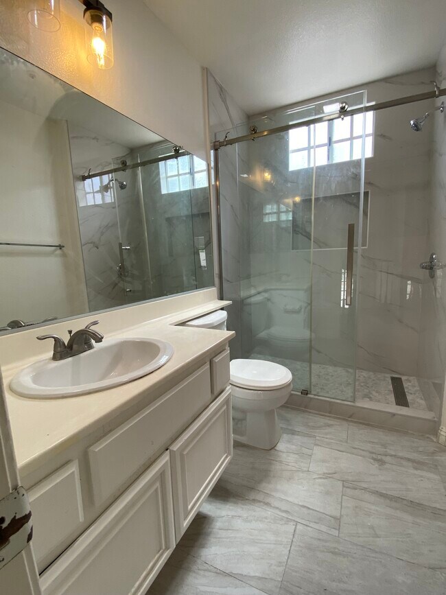 New shower with new tiling and flooring in upstairs bathroom - 915 W Arrow Hwy