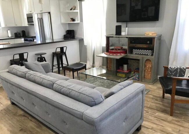 Living room with view to kitchen and bar for 4 stools - 6735 Saint Clair Ave