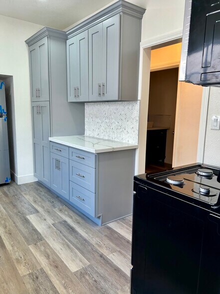 Spacious kitchen with abundant cabinet space for easy storage. - 4043 1/2 W 21st St