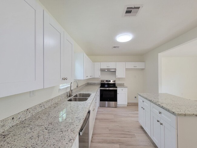 Building Photo - REMODELED 4 BEDROOM 2 BATH LEASE HOME IN A...