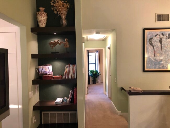 bookcase and hall - 4531 Chateau Dr