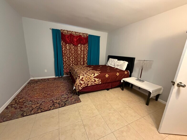 Large primary bedroom with generous closet space and en-suite bathroom. - 8427 Hearth Dr
