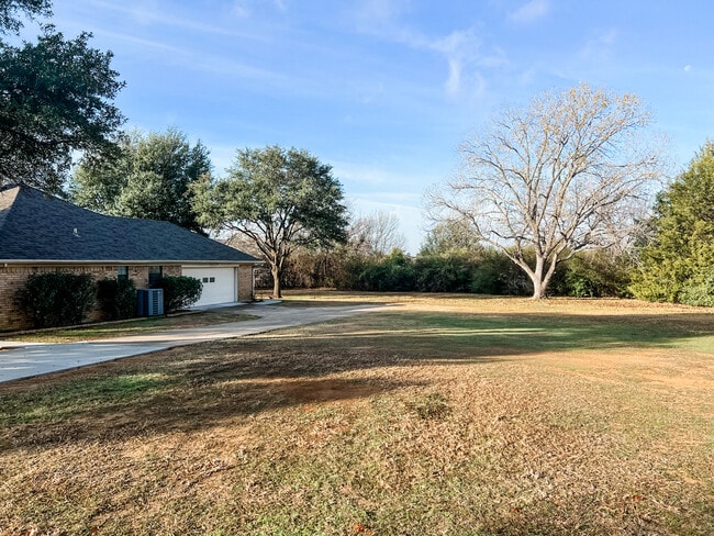 Long driveway with 2-car garage. 1-acre lot, landscaping overhauled. Grass planted. - 400 Pine Dr