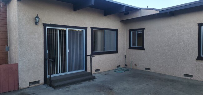 Building Photo - This is a spacious house featuring four bedrooms and two bathrooms, along with a two-car garage.