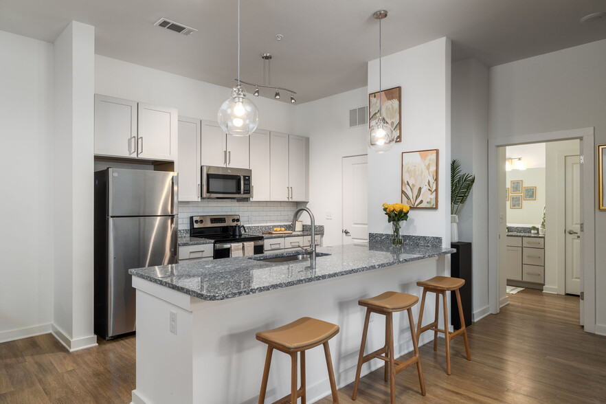 Spacious Kitchen with Granite Countertops - The Leo Loso Apartments