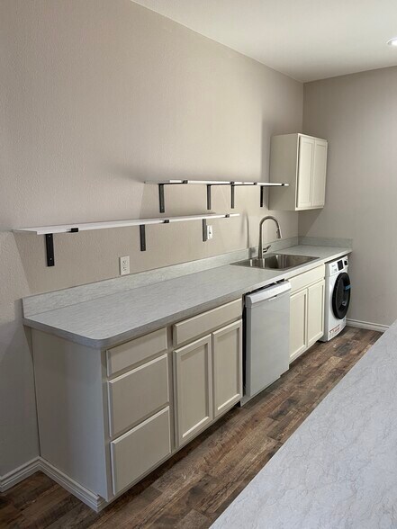 Galley Kitchen with Open Shelving and Washer Dryer Unit. - 5313 Sam Calloway DR.