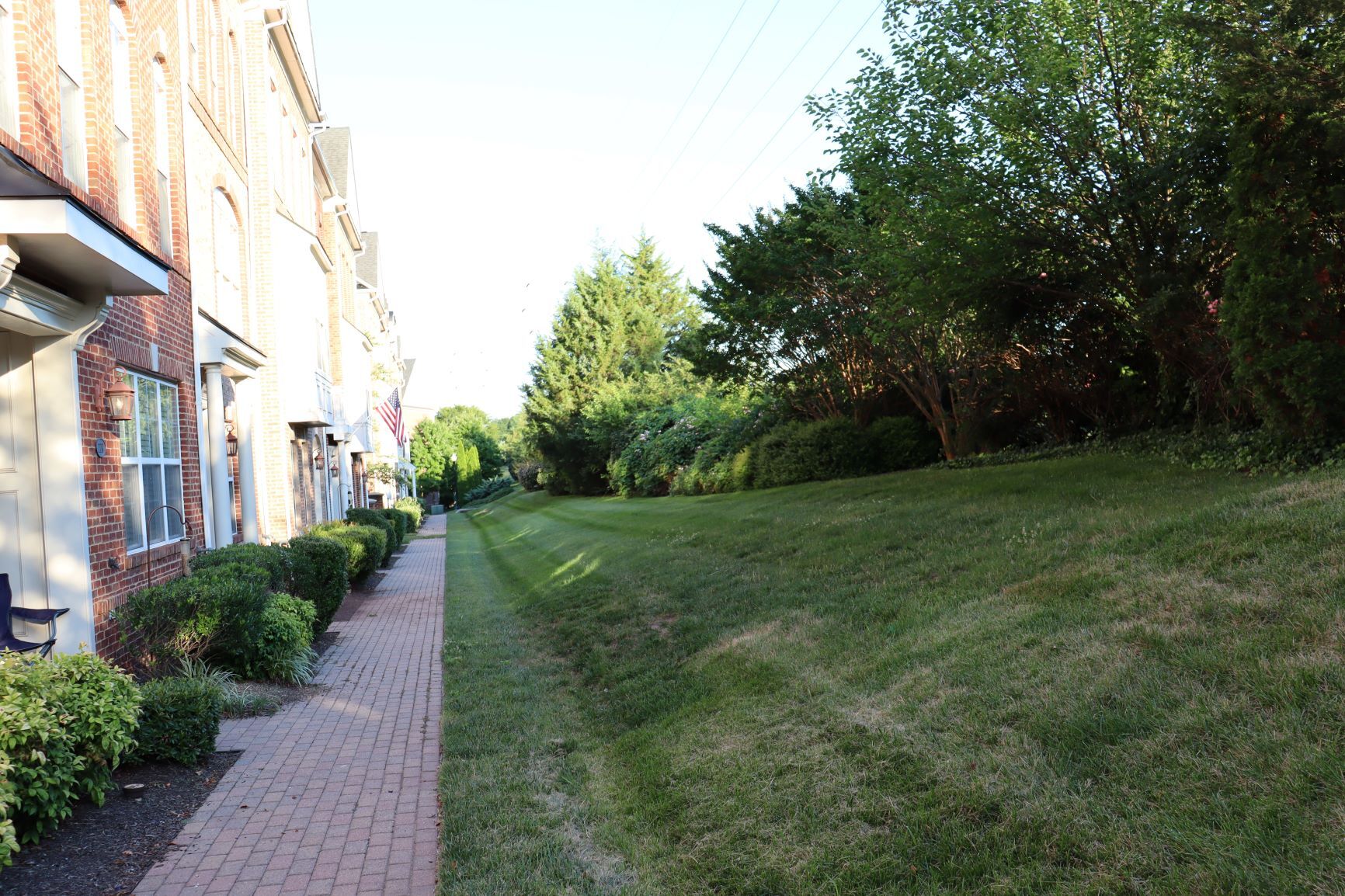 Lush landscaping with the W&OD trail directly behind the greenery - 222 Herndon Station Sq