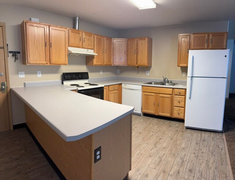 Bright and open kitchen featuring wraparound countertops, full-size appliances - 2979 Badger Rd