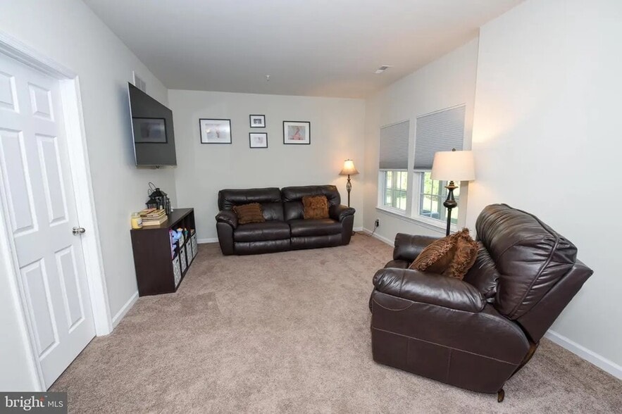 Additional first-floor living space just inside the garage entry—ideal for a home office, gym, or pl - 1736 Beacon Ln