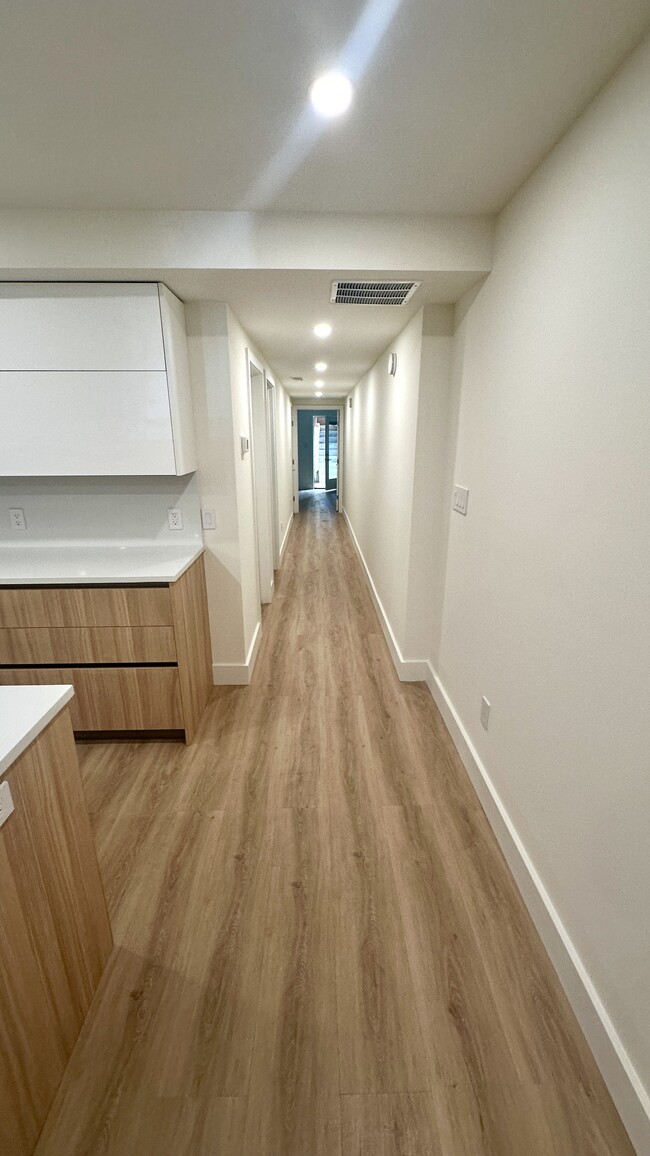 Corridor that leads to second bedroom, second bath, and master bedroom and bath. - 1644 Irving St NW