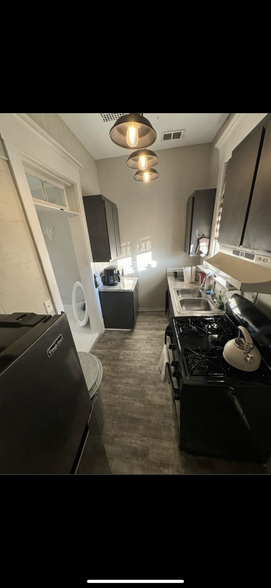 Kitchen, brand new oven and fridge. - 115 W 36th St