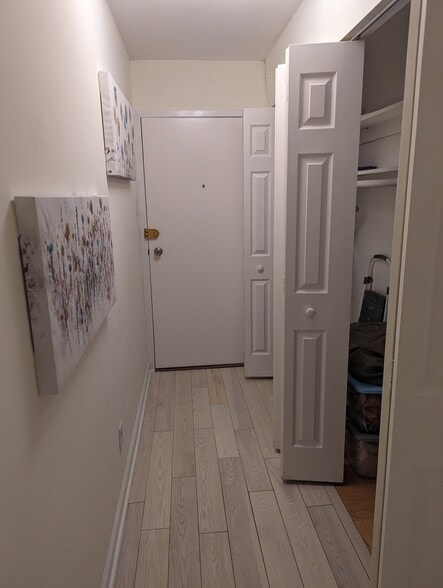 Entryway with both sets of closet doors open - 575 Thayer Ave