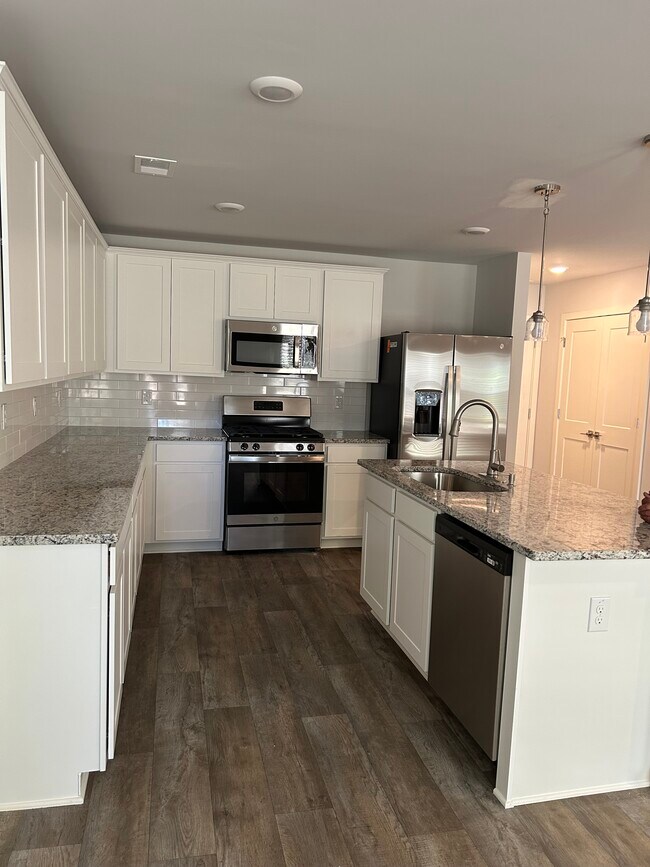 Kitchen from the dining area. - 226 River Meadow Dr