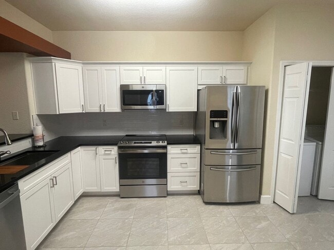Building Photo - Stunning townhome in gated community near ...