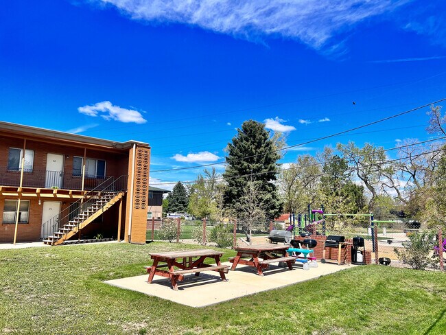 Enjoy outdoor living with ample seating and a fun play area for kids. - Westland Apartments