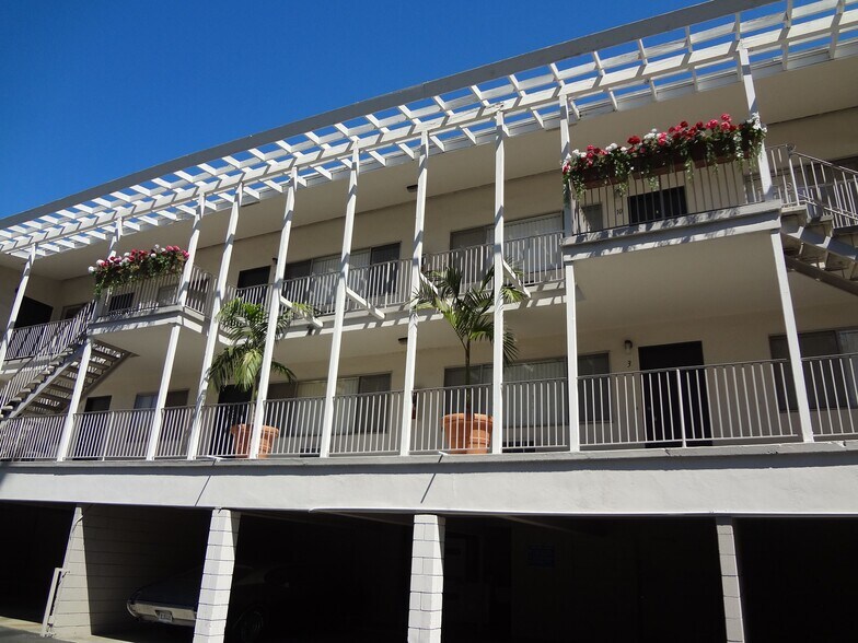 Garages below balcony enterances to apartments at Villa Knolls Apartments in La Mesa, California. - Villa Knolls Apartments