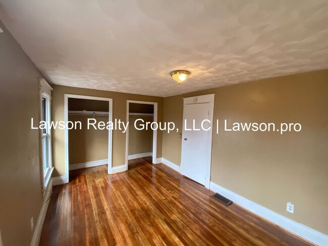Building Photo - Updated Three Bedroom with Flat Yard