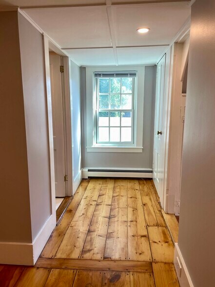 The bathroom and second bedroom are located at the end of the hall opposite the first bedroom. - 20 Chapel St