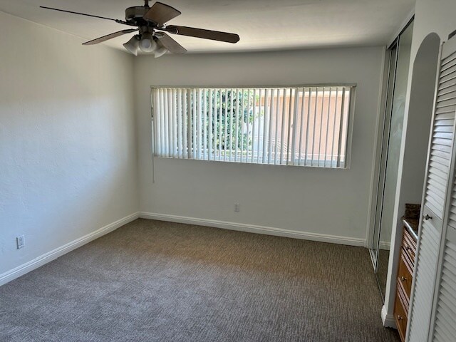 Spacious bedroom with ceiling fan and clean carpet. - 5510 Adelaide Ave