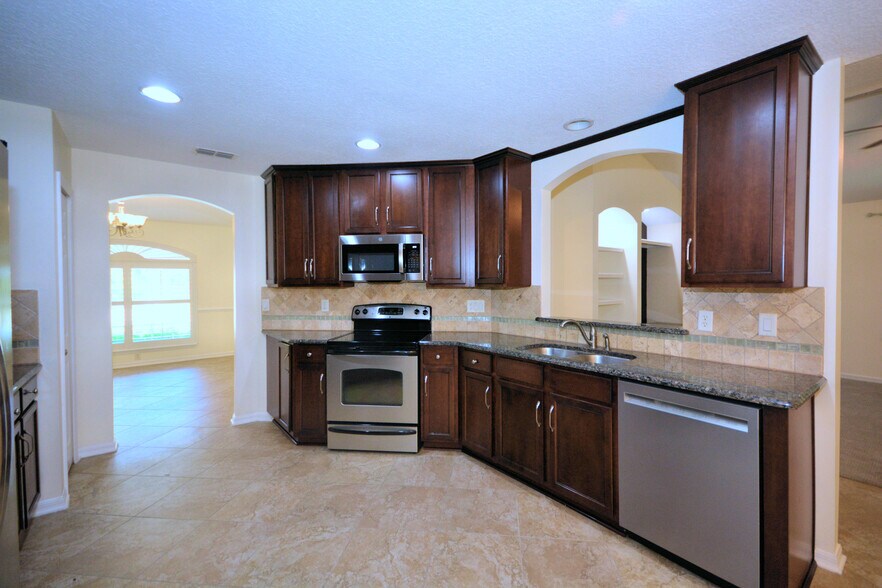 Kitchen with dining in left background - 4538 Palmetto Cove Ln