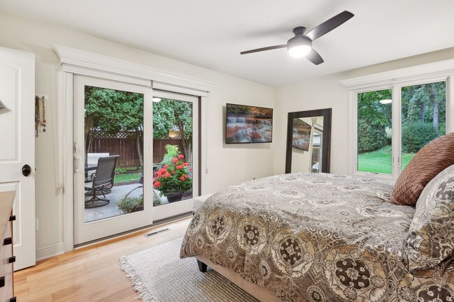 Primary bedroom is filled with natural light, plus offers access to the back patio - 245 Inland Ln N