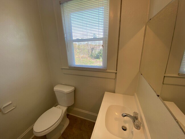 Building Photo - 1,550 square feet in Trinity Park. High ceilings, French doors, and a porch worth sitting on.