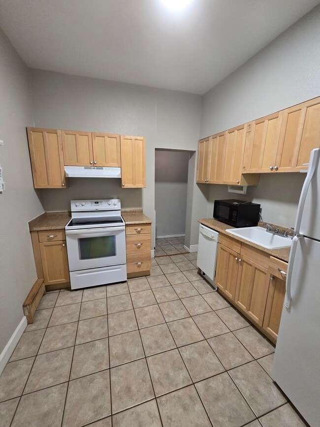 Building Photo - This updated and welcoming condo in the he...